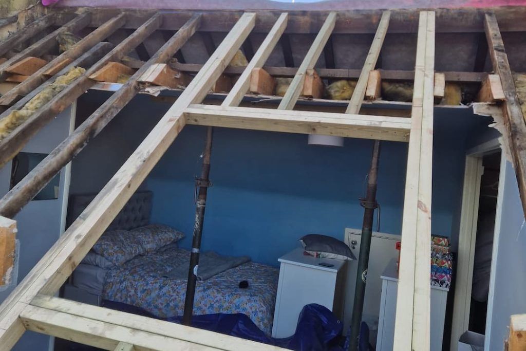 a bedroom under construction with a bed and a blue wall